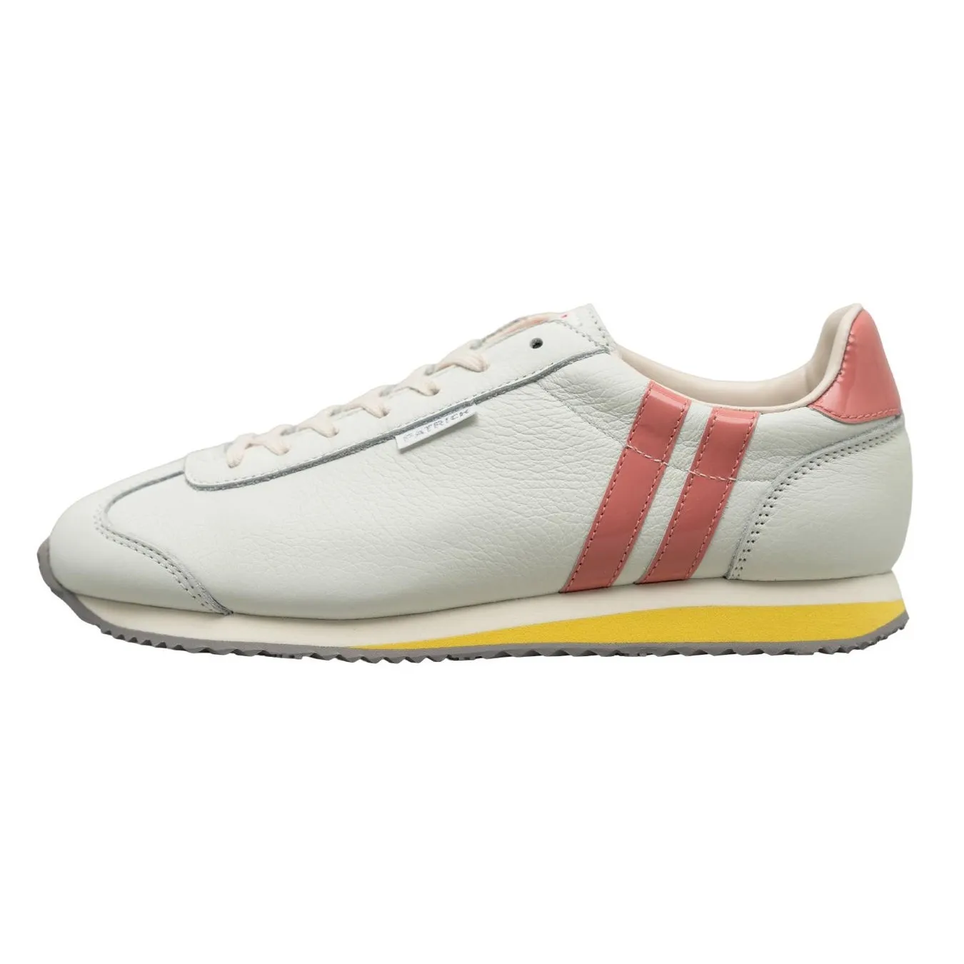 白いスニーカー。ピンクのストライプが特徴で、黄色いソールがアクセント。