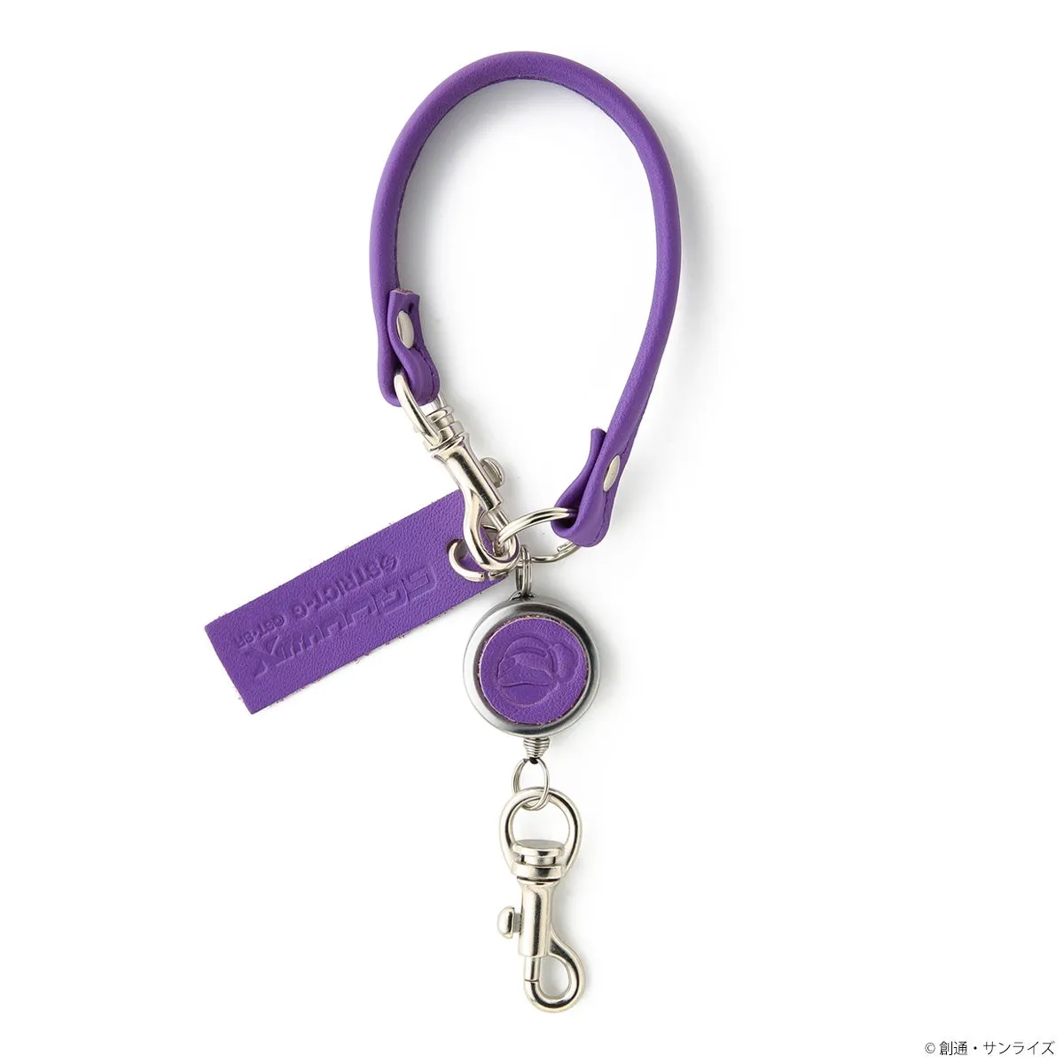紫色のネックストラップとリールキーホルダーのセットです。ネックストラップは革製で、リールキーホルダーにはキャラクターのマークが刻印されています。