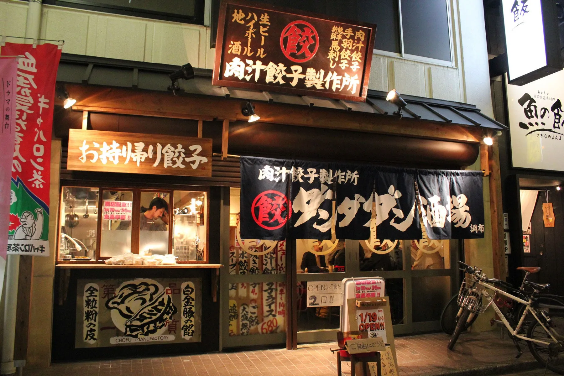 日本の餃子専門店の外観。看板には「肉汁餃子製作所」と書かれており、テイクアウト餃子も提供している。