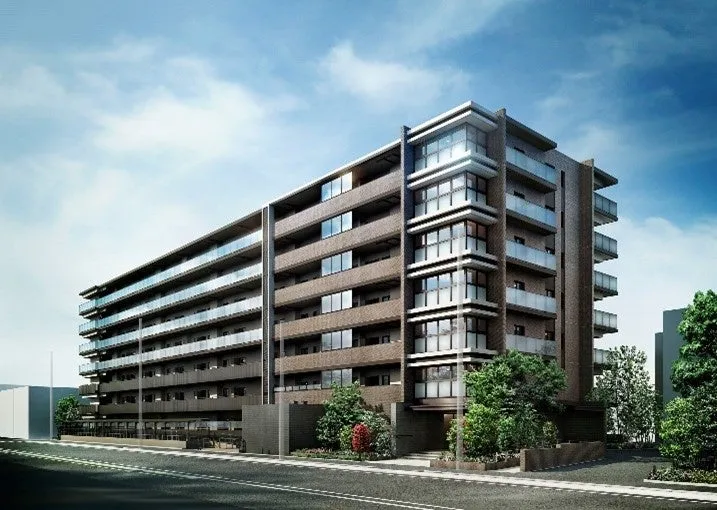 マンションの外観のCGパースです。青空の下、近代的なデザインの建物が建っています。